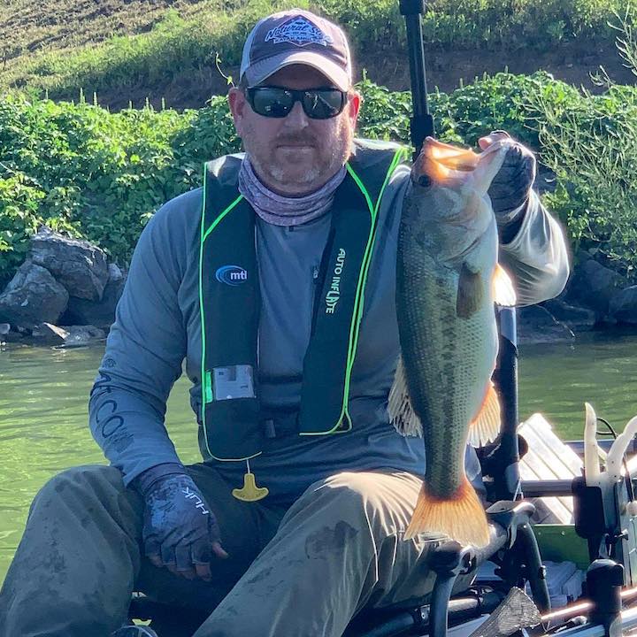 Bending Branches ProStaffer Jason Kincy, holds up a fish