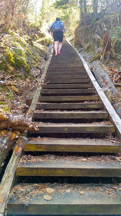 woman hiking up the steps at Stairway Portage