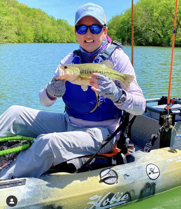 kayak angler, Courtney Bennett, in her kayak with a fish