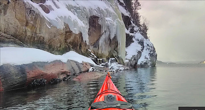 kayaking along an icy shoreline