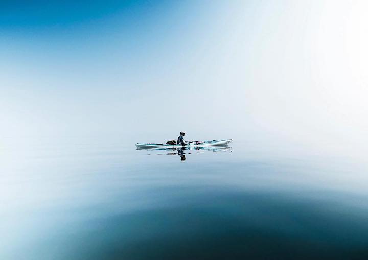 kayaker on glassy water