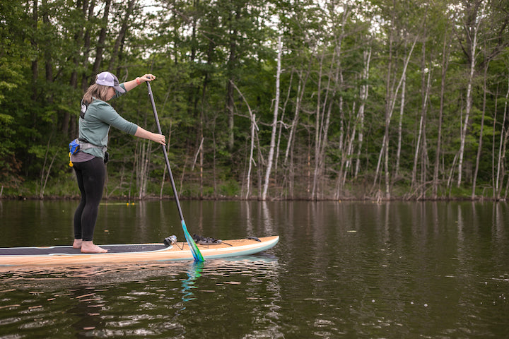 woman on a paddleboard on a lake