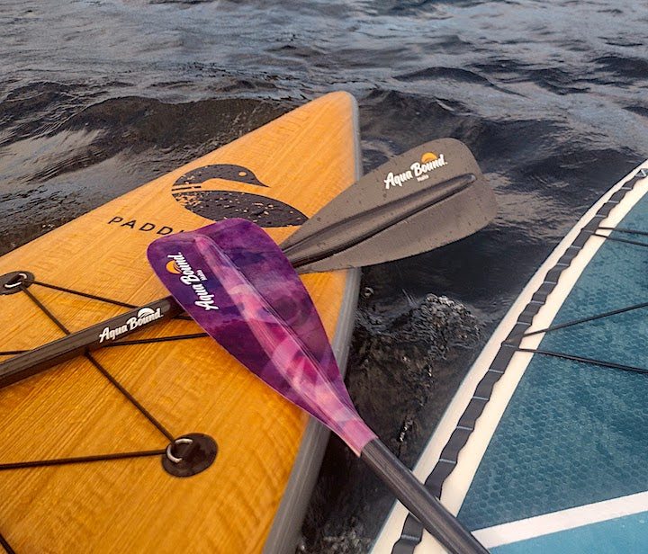 two Aqua Bound paddle blades on two SUP boards on the water