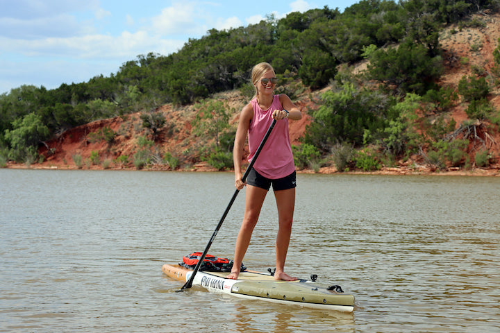 woman on a SUP looking ahead while she paddles