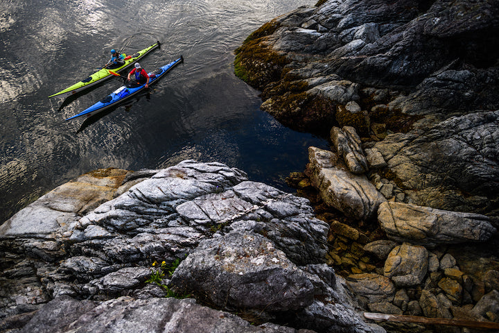 sea kayakers by the rocks