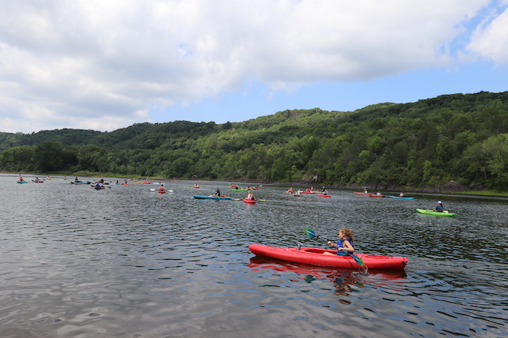 Aqua Bound company float day - families in kayaks and canoes on the river