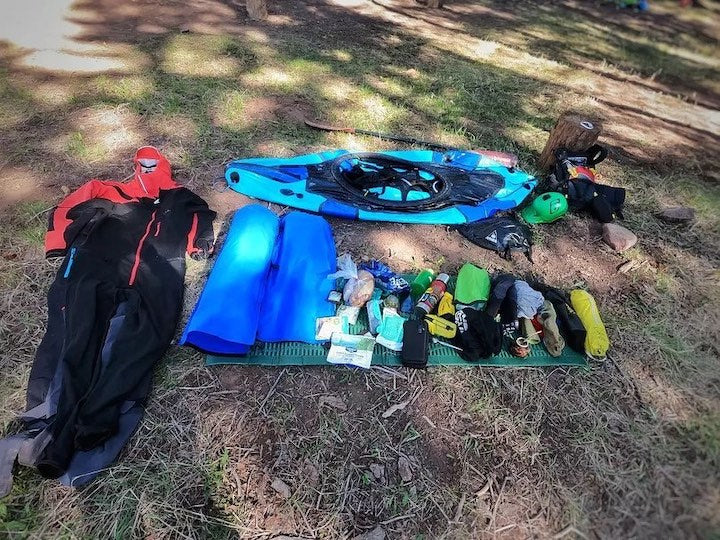 Packraft gear laid our on the grass