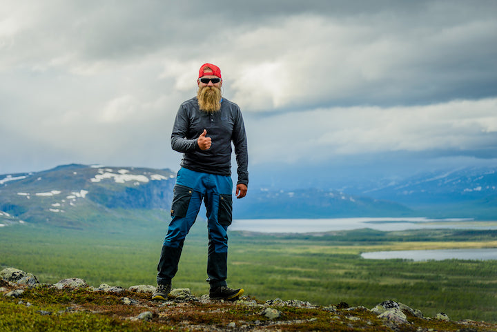 Caj Koskinen standing in front of a broad arctic landscape