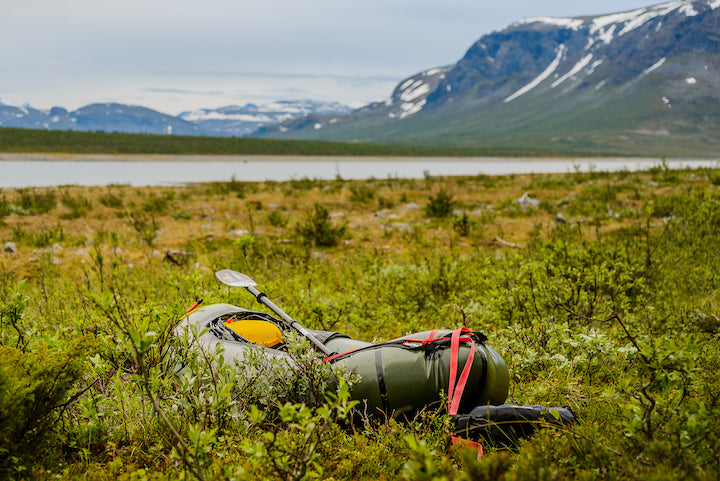 packraft sitting on tundra in sweden's arctic wilderness