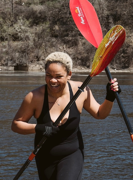 Devin Brown, laughing, with her two Aqua Bound paddles