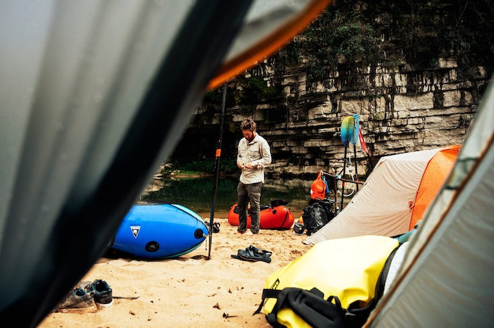 dry bags and tents at a packraft campsite