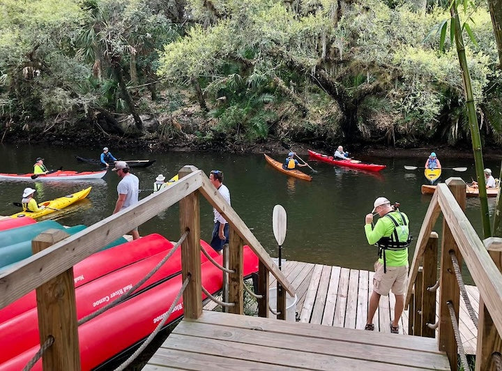 people in rental and demo kayaks on the dock from Estero River Outfitters