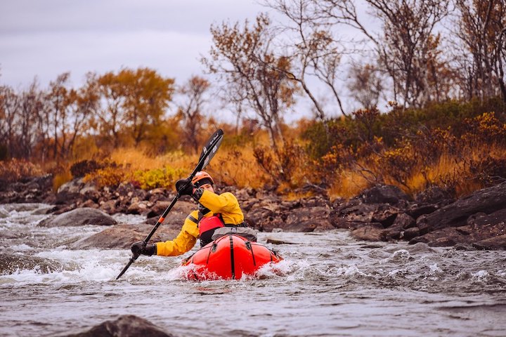 paddler in a packraft on whitewater