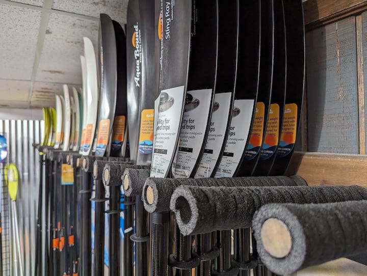 Aqua Bound paddles on the wall inside Get Outdoors