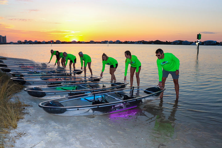 Glow Paddle staff getting kayaks ready for their guests