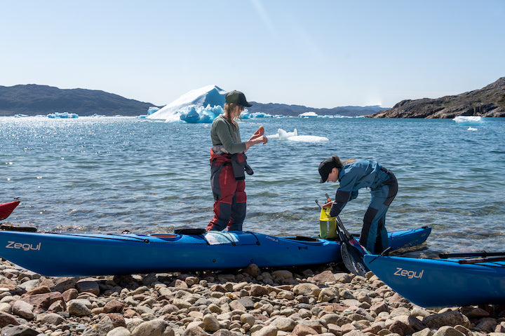 two women prepare to take sea kayaks out