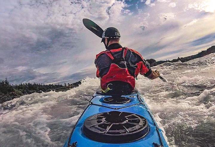 man kayak surfing