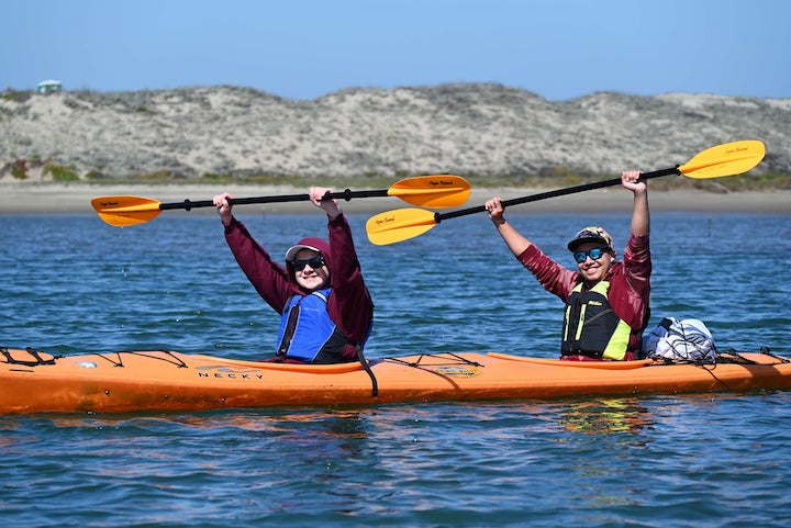 kayakers with hi-viz paddles