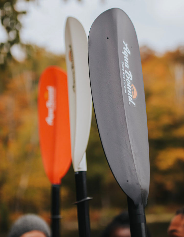 kayak blades in three different colors, red, white and black