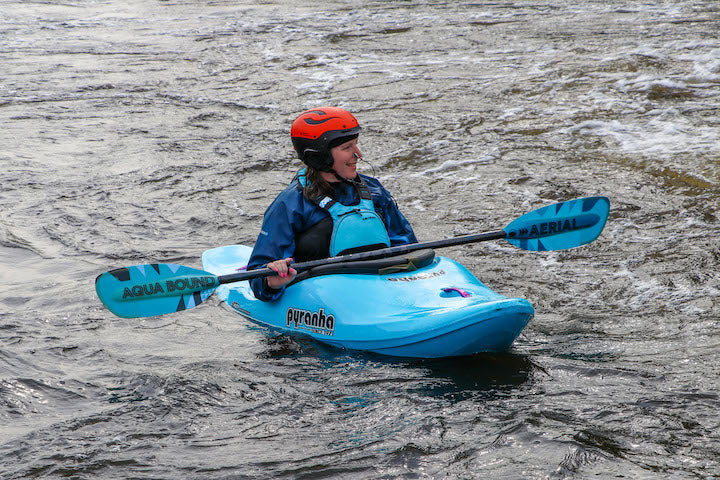 whitewater kayaker on the river with Aqua Bound's Aerial Fiberglass paddle