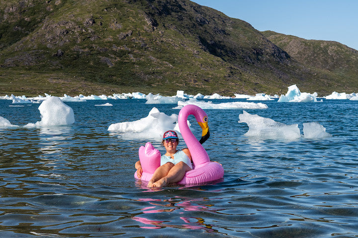 Kate and the pink flamingo among small icebergs in Greenland