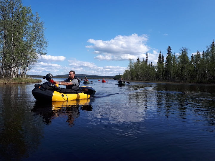 several packrafters on a river in Swedish Lapland