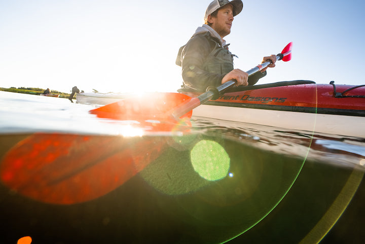 close-up of a man kayaking with the Sting Ray Hybrid in a red kayak