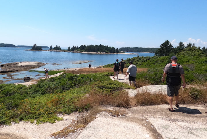 several people hike on an island 