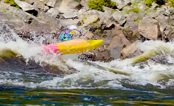 whitewater kayaker shooting through big waves on the Ottawa River