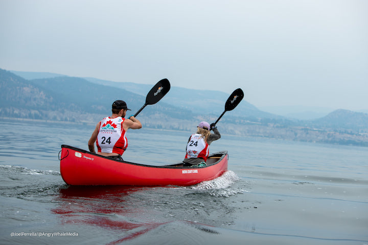 two people in a tandem canoe during a race