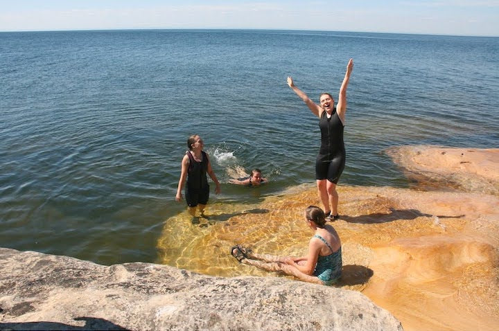 4 women swim off the rocks in Lake Superior