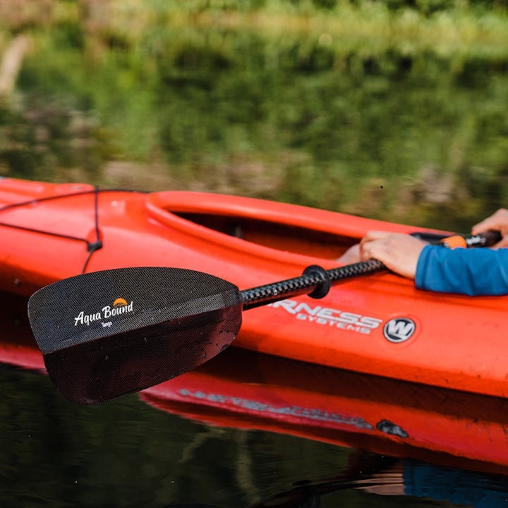 Aqua Bound's Tango Carbon paddle held by kayaker on the water