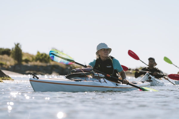 older woman paddling with the Tango Northern Lights paddle