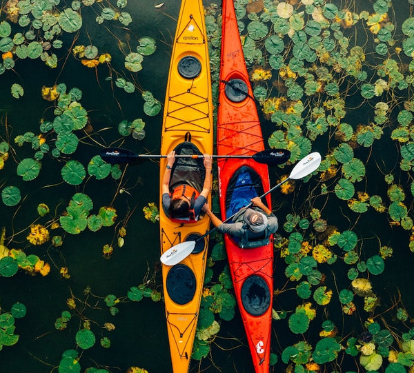 two kayaks with the manta ray carbon and hybrid white aerial shot with lily pads