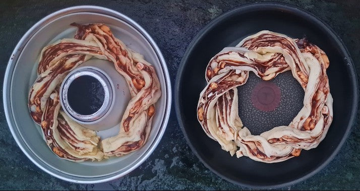 Omnia oven and skillet side by side, each with Italian treccia ready to bake