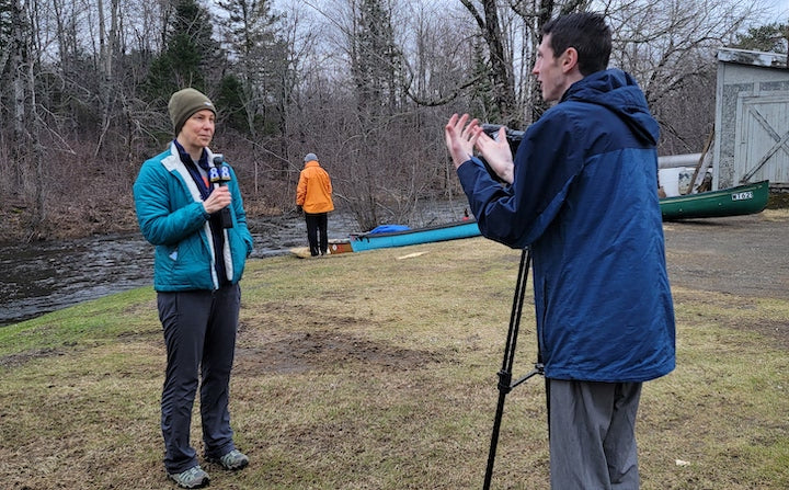 woman speaking into a mic with interviewer