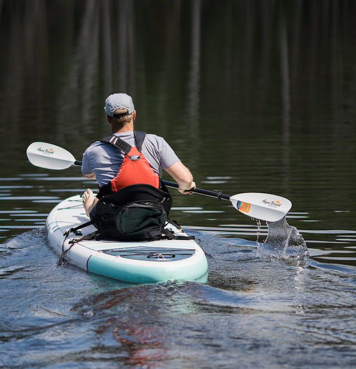 man paddling a hybrid SUP/kayak