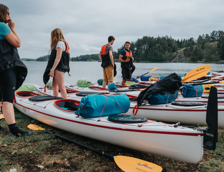 group getting kayaks and gear ready for a trip