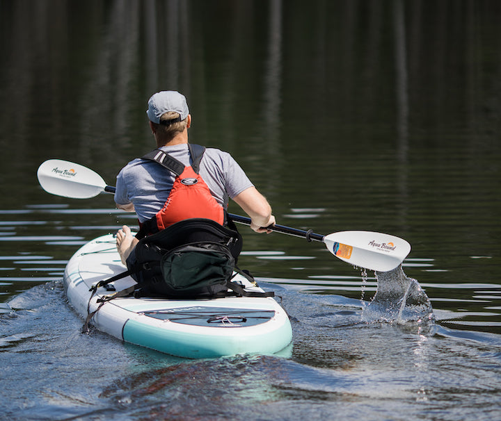 man paddling a SUP/sit-on-top kayak hybrid
