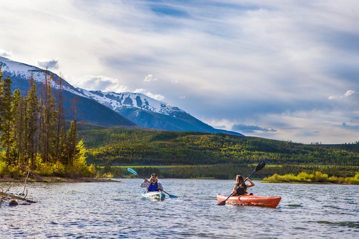 two kayakers on a mountain lake