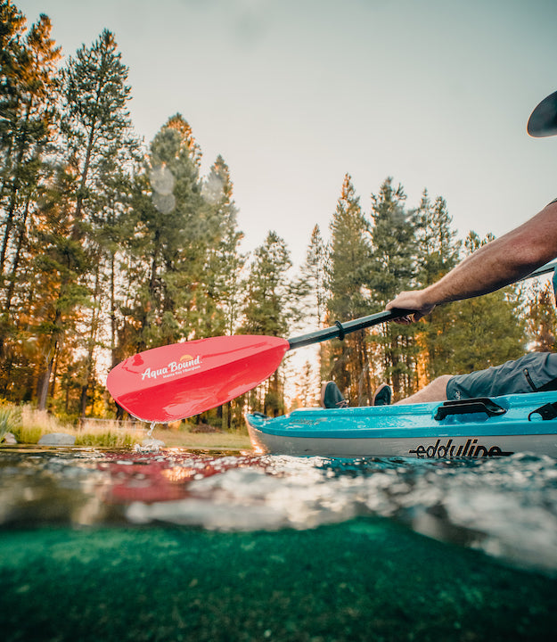 kayaker with red Aqua Bound paddle 