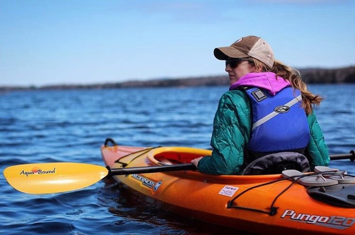 woman kayaking with sunglasses