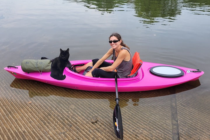 woman and her cat in a kayak ready for the water