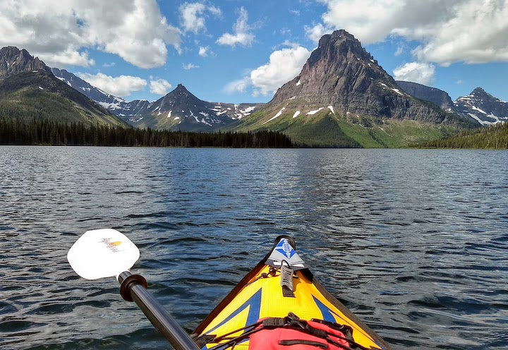 kayaking on a mountain lake, surrounded by mountains