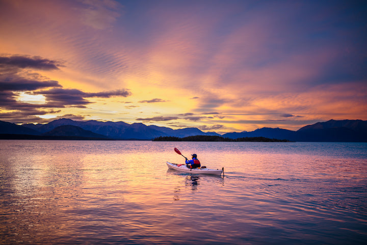 long shot of a kayaker at sunset