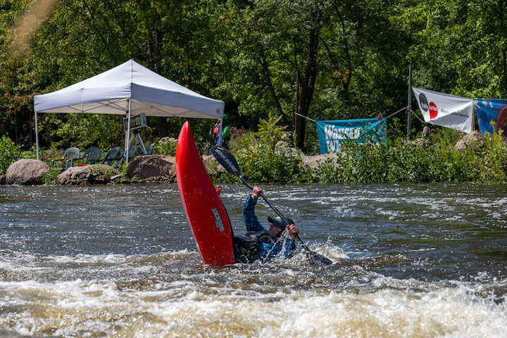whitewater kayaker does a pivot turn