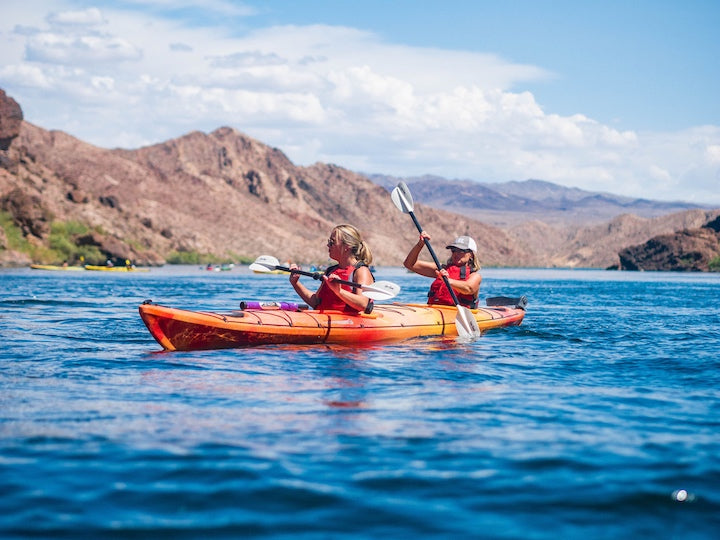 two women paddling a tandem kayak in the American southwest