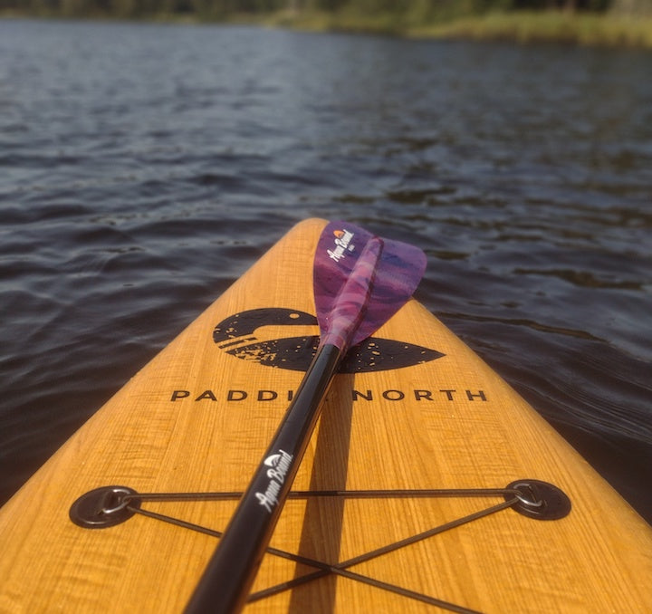 front end of a paddleboard on the water with an Aqua Bound Malta paddle