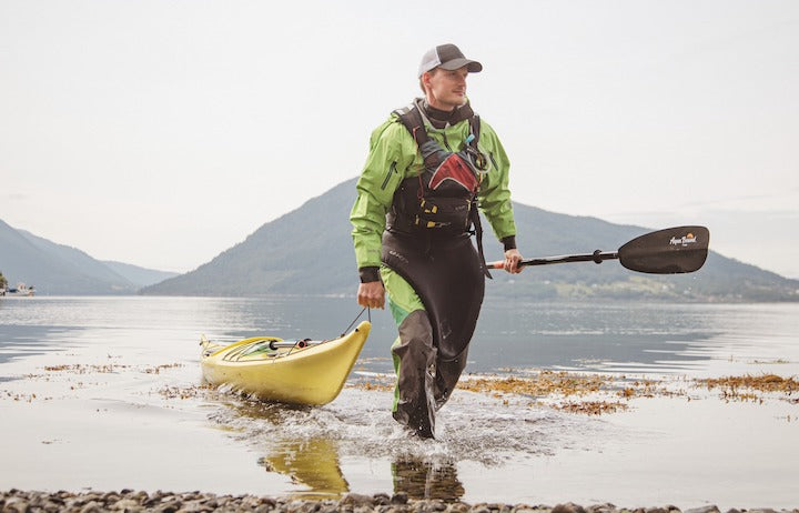 man with kayak on shore