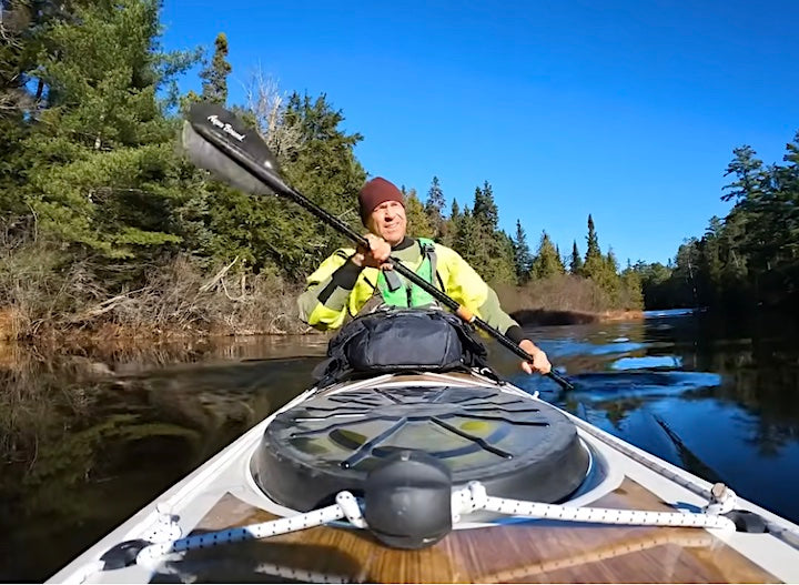 Ken Whiting paddles his sea kayak on a wilderness lake